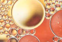 Burbujas de aceite sobre fondo anaranjado: L-carnitina tartrato